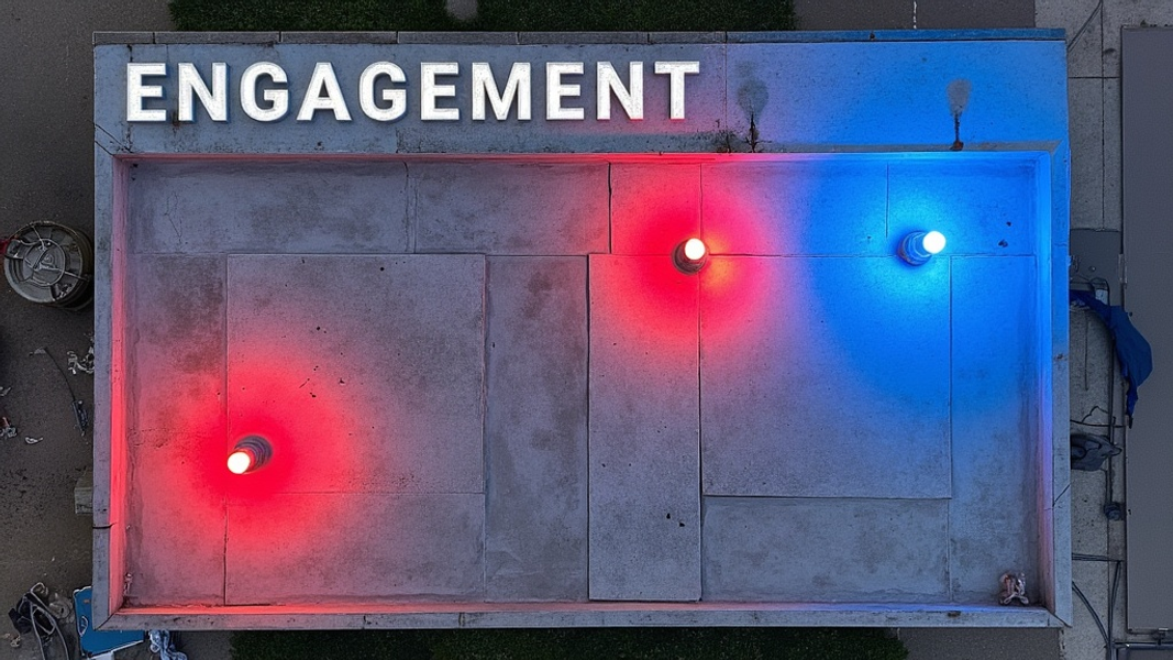 A bird's-eye view of a rectangular surface divided into sections, with some areas highlighted in vibrant red and others in cool blue tones, and there's written "ENGAGEMENT" with large bold font on the top corner