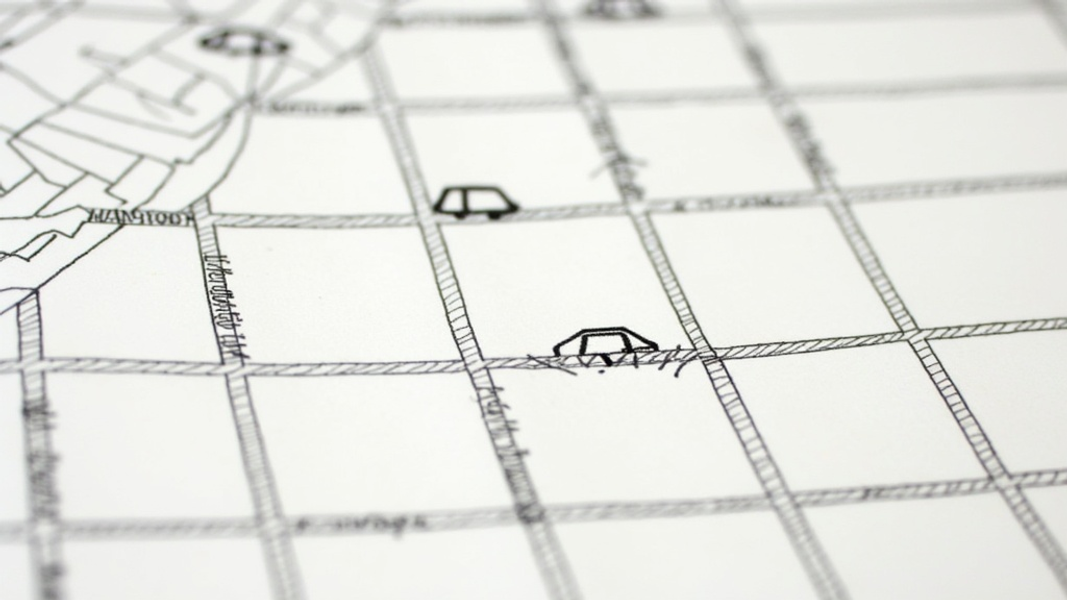 A close-up of a hand-drawn map of San Francisco's streets with a few small car symbols scattered sparsely across it, suggesting a limited initial service rollout
